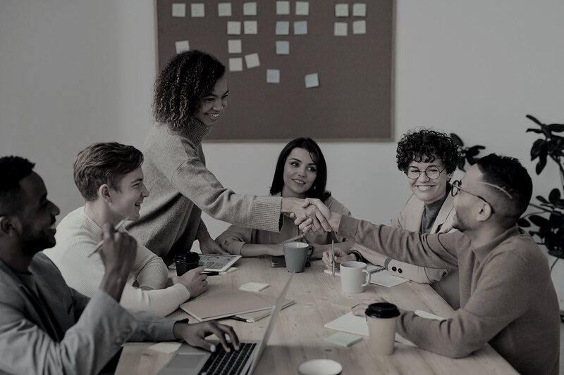 Client meeting in progress with team members discussing customer acquisition goals